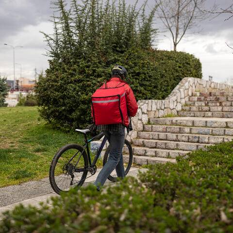 An inconspicuous delivery person in a neighborhood